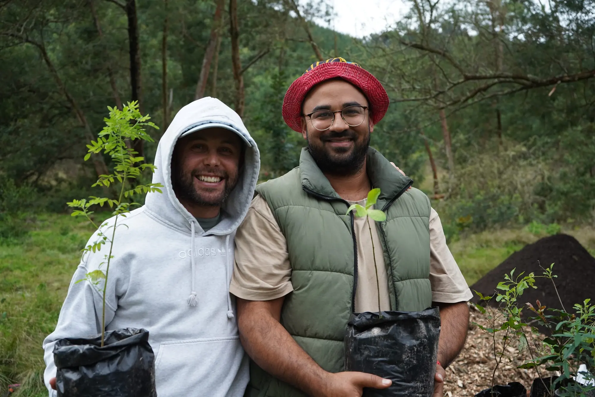 Volunteers holding a fresh root ball of soil ready for planting