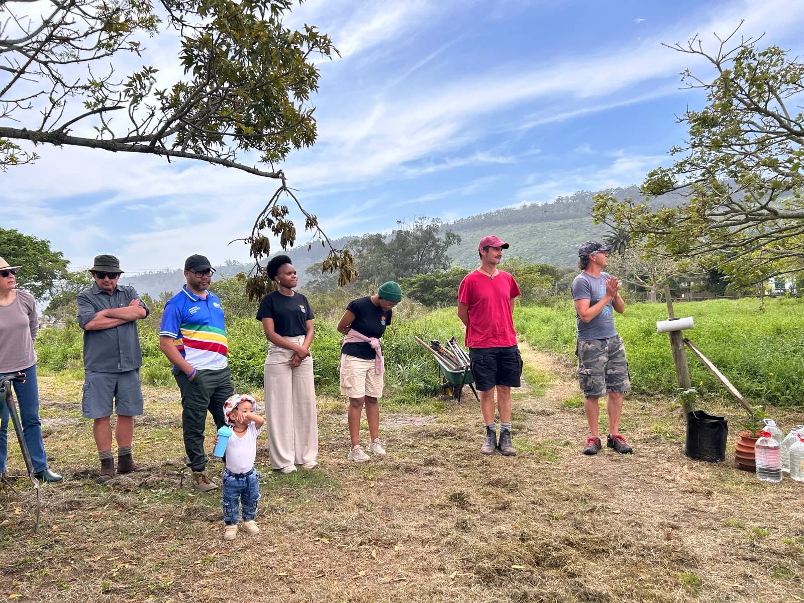 Residents listening to the briefing on the Village Green, the Outeniqua foothills behind