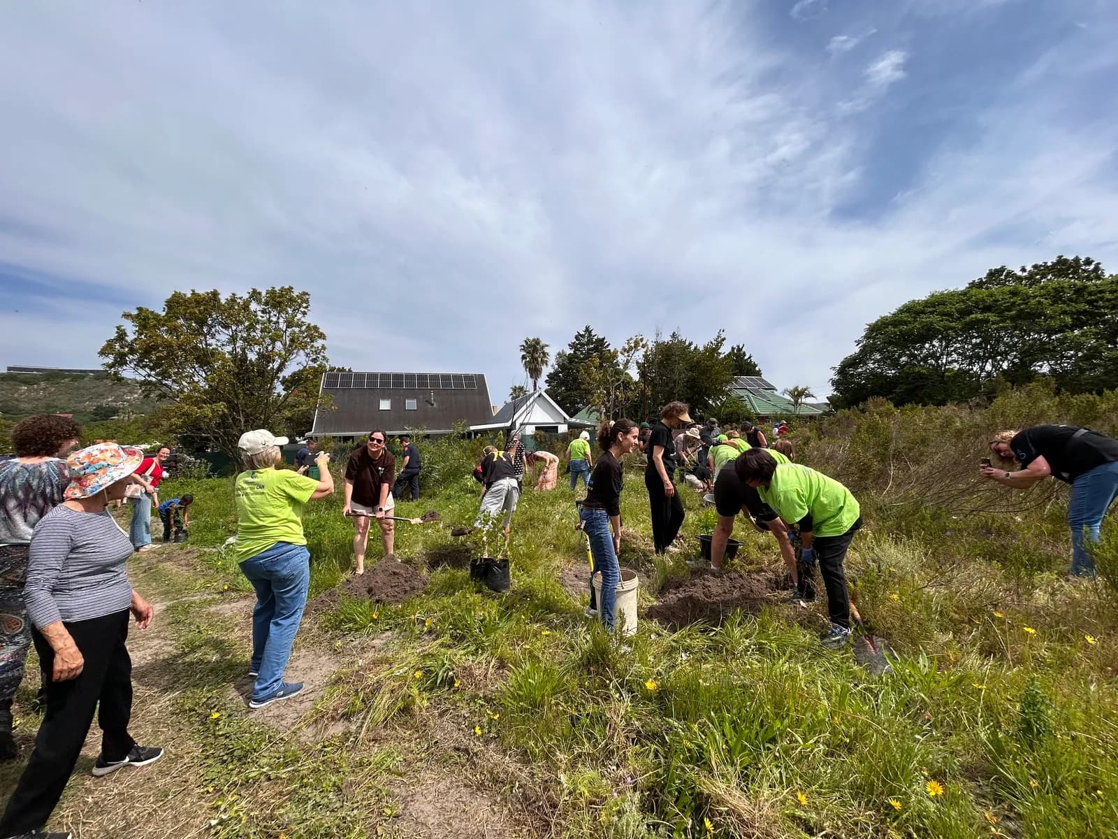 The full group spread across the Village Green, breaking ground for the Pocket Forest